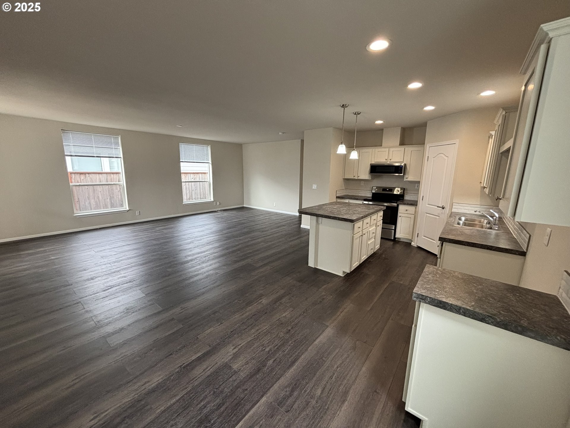 5270 Nopal Street Florence, OR 97439 - Photo 6 of 27 a kitchen with stainless steel appliances granite countertop wooden floors and stove
