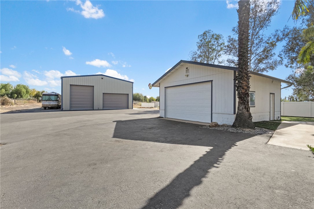 35825 Meadow Ridge Road Temecula, CA 92592 - Photo 59 of 75 a front view of a house with a yard and garage