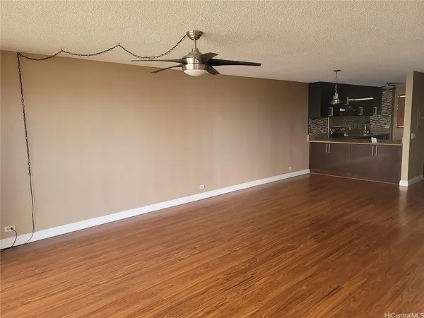 a view of a room with wooden floor