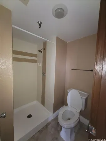 a bathroom with a toilet and a shower