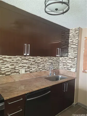 a view of granite countertop cabinets and sink