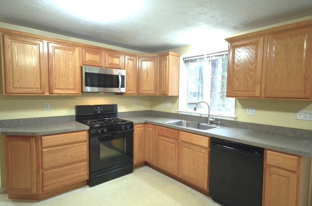 12 Leon Road Holbrook, MA 02343 - Photo 3 of 23 a kitchen with a sink stove and microwave