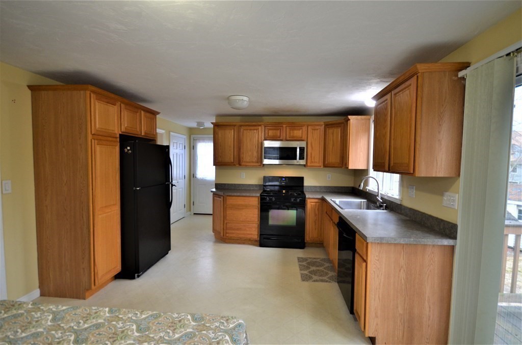 12 Leon Road Holbrook, MA 02343 - Photo 4 of 23 a kitchen with stainless steel appliances granite countertop a refrigerator stove top oven a sink and dishwasher