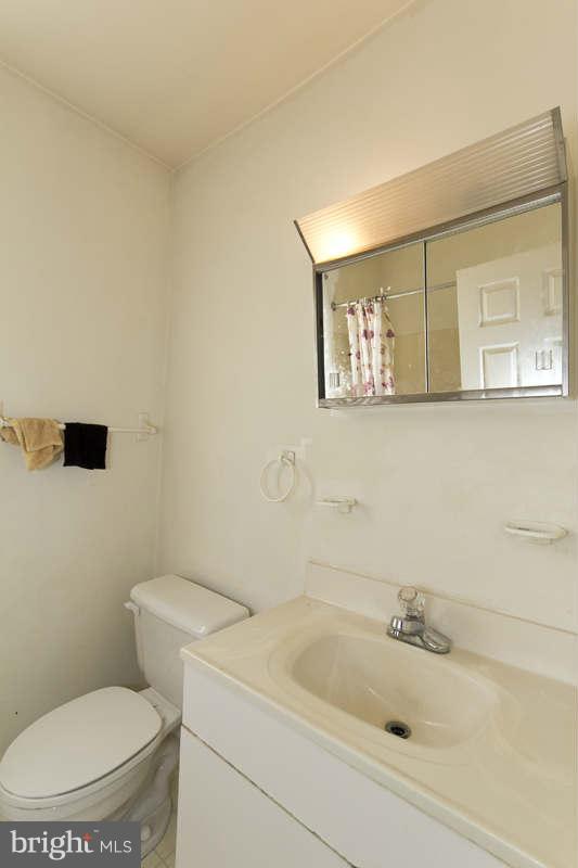 509 Kingston Road Baltimore, MD 21229 - Photo 12 of 17 a bathroom with a toilet and a sink