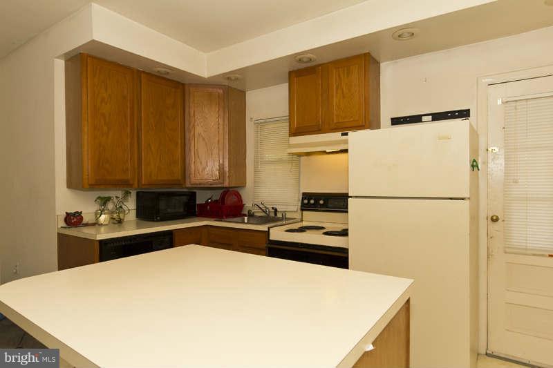 509 Kingston Road Baltimore, MD 21229 - Photo 13 of 17 a kitchen with a refrigerator and a stove
