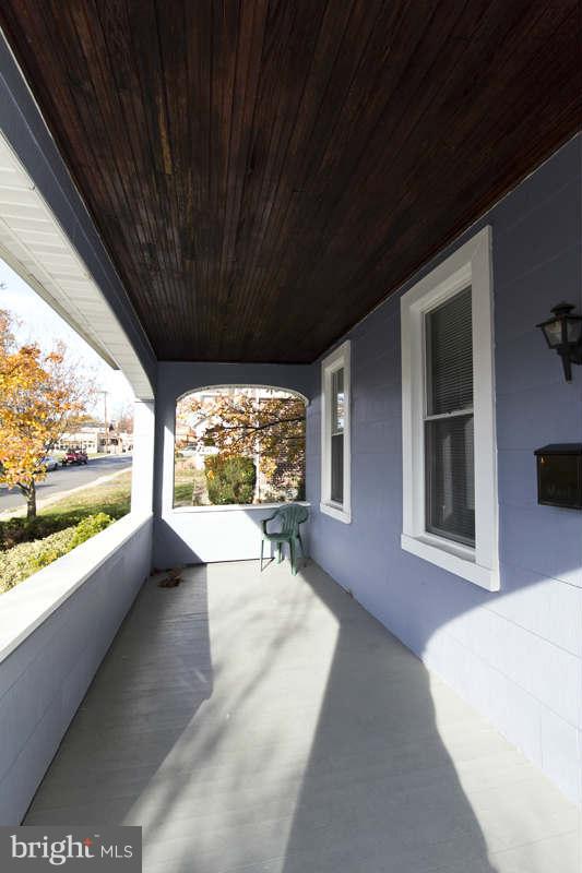 509 Kingston Road Baltimore, MD 21229 - Photo 3 of 17 a view of a porch with furniture and a yard