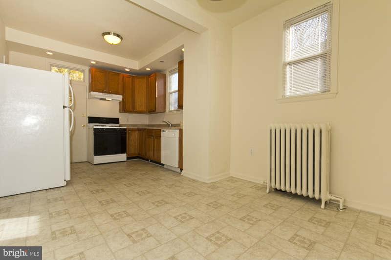 509 Kingston Road Baltimore, MD 21229 - Photo 5 of 17 a view of a kitchen with a sink and a refrigerator