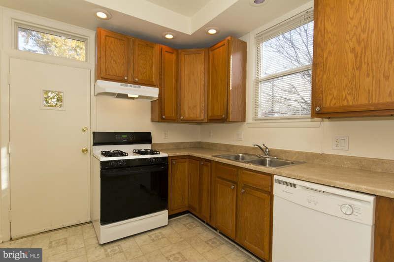509 Kingston Road Baltimore, MD 21229 - Photo 6 of 17 a kitchen with stainless steel appliances granite countertop a stove a sink and a microwave