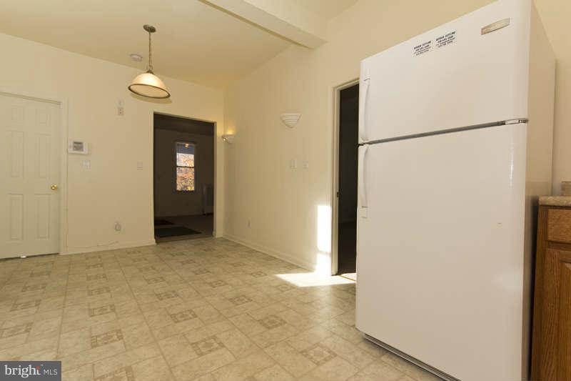 509 Kingston Road Baltimore, MD 21229 - Photo 7 of 17 a view of a kitchen with refrigerator and cabinet