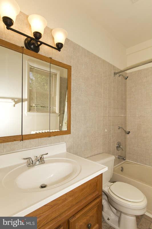 509 Kingston Road Baltimore, MD 21229 - Photo 9 of 17 a bathroom with a sink a toilet and shower