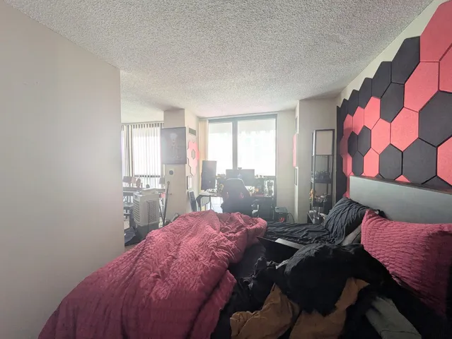 a bed room with a bed and a chair