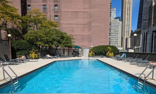 a swimming pool with outdoor seating and yard