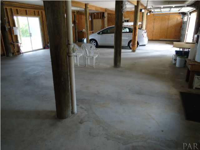 7840 Petersen Point Road Milton, FL 32583 - Photo 15 of 24 On the other side of the car their is an enclosed storage room.