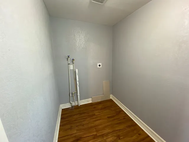 a view of a room with wooden floor