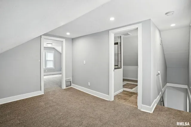 an empty room with closet and wooden door