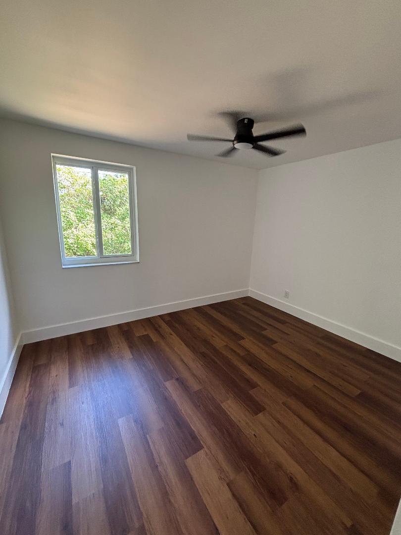 5724 Seton Drive Margate, FL 33063 - Photo 6 of 12 a view of a room with wooden floors and a window