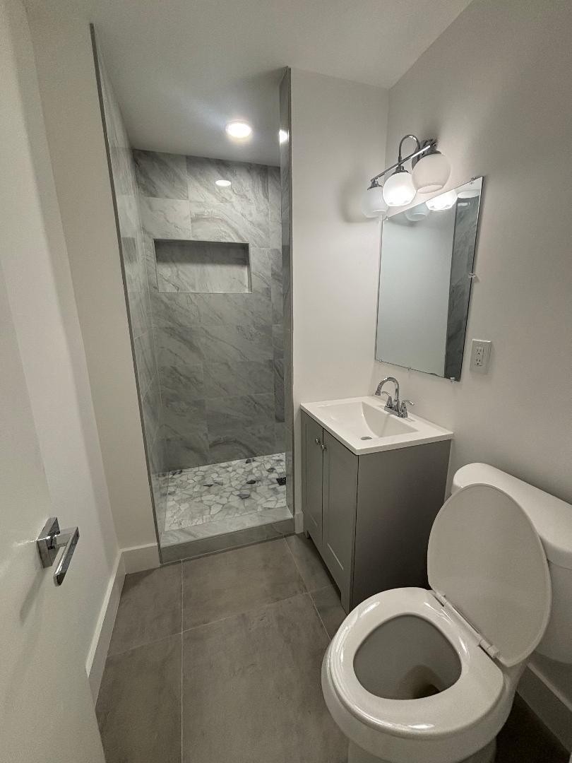 5724 Seton Drive Margate, FL 33063 - Photo 8 of 12 a bathroom with a toilet sink and mirror