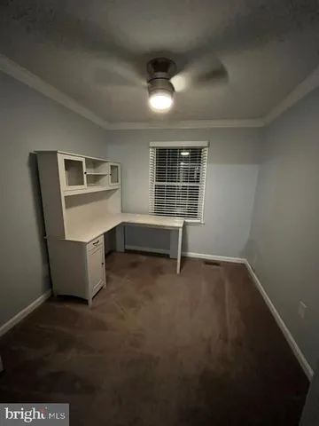 a view of a livingroom with an empty space and a window