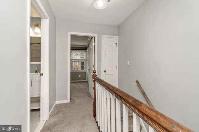 a view of a hallway with wooden floor and entryway