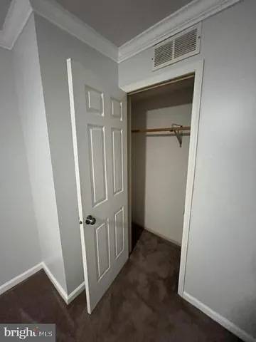 an entryway door with a hallway in the house