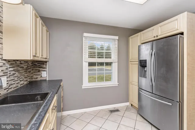 a kitchen with a refrigerator and a sink