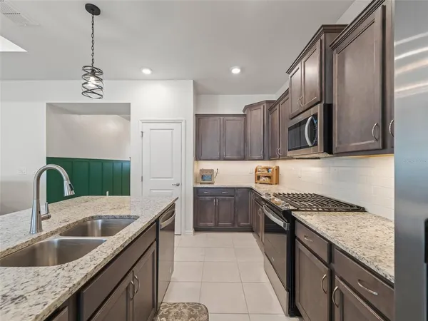 a kitchen with stainless steel appliances granite countertop a sink and stove