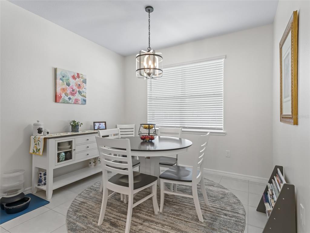 7206 Southwest 60th Lane Ocala, FL 34474 - Photo 13 of 50 a view of a dining room with furniture window and wooden floor