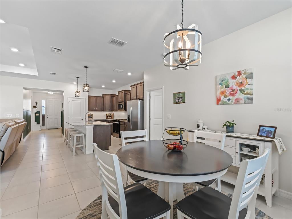 7206 Southwest 60th Lane Ocala, FL 34474 - Photo 14 of 50 a view of a dining room with furniture and a chandelier