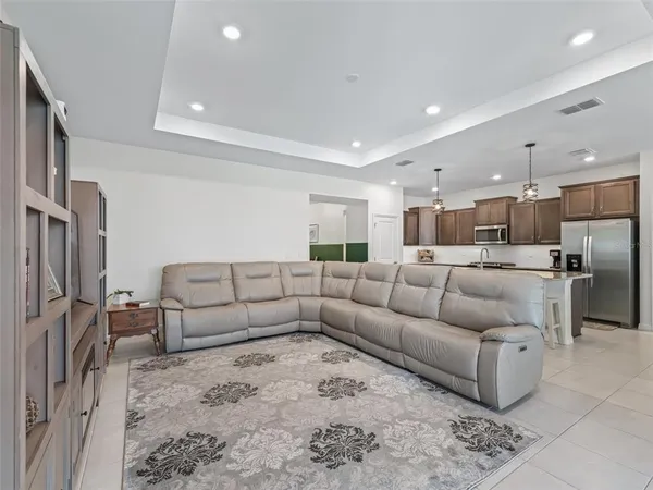 a living room with furniture and kitchen view
