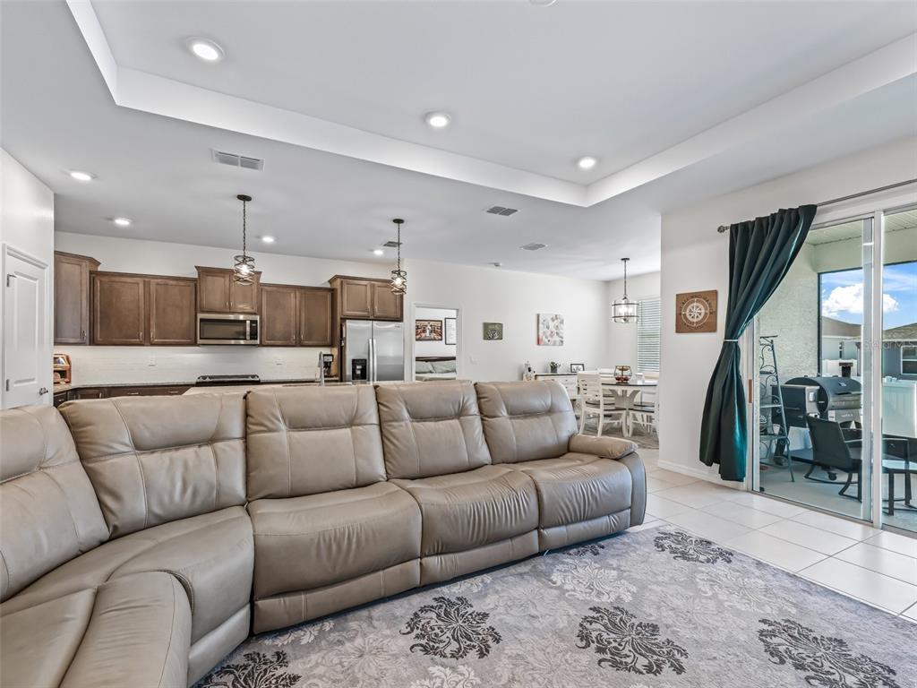 7206 Southwest 60th Lane Ocala, FL 34474 - Photo 19 of 50 a living room with furniture and a view of kitchen
