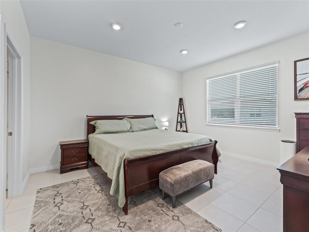 7206 Southwest 60th Lane Ocala, FL 34474 - Photo 21 of 50 a bedroom with a bed mirror and a window