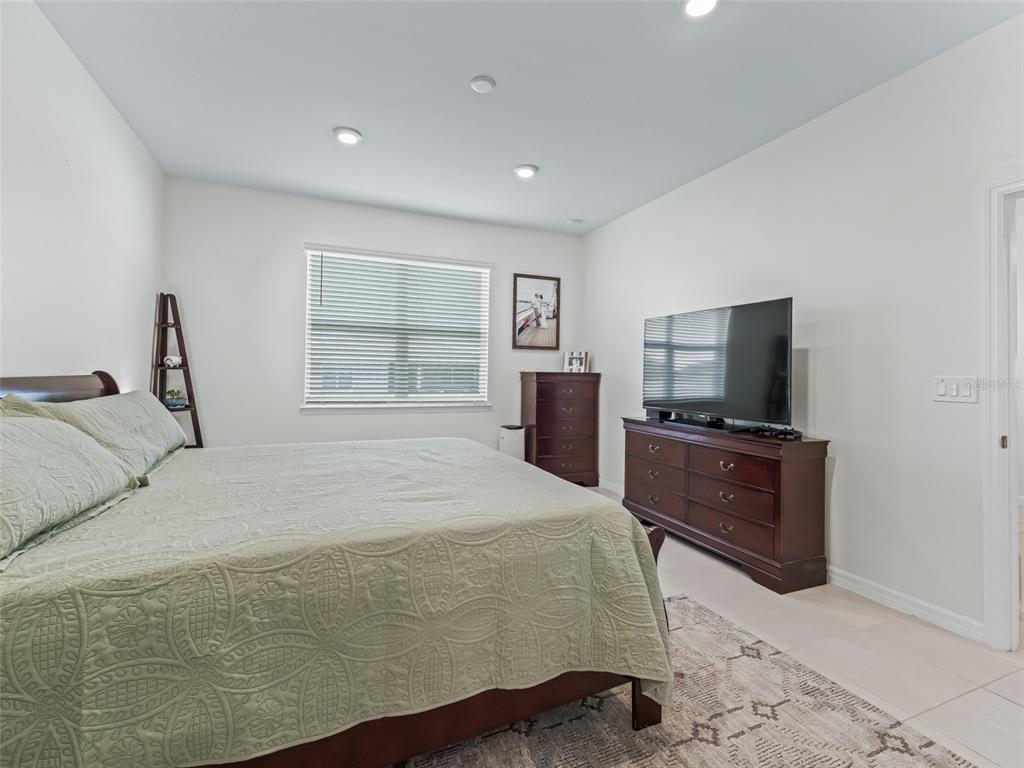 7206 Southwest 60th Lane Ocala, FL 34474 - Photo 22 of 50 a bedroom with a bed and a flat screen tv
