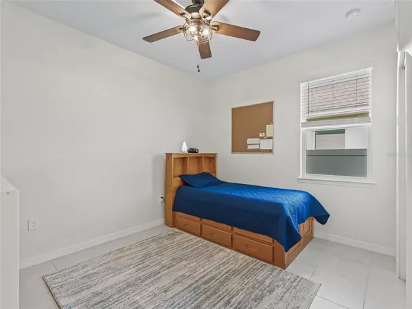a bedroom with a bed and window