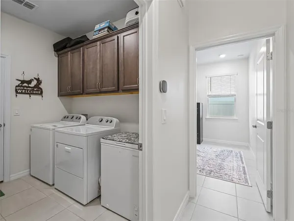 a view of a storage & utility room with a sink