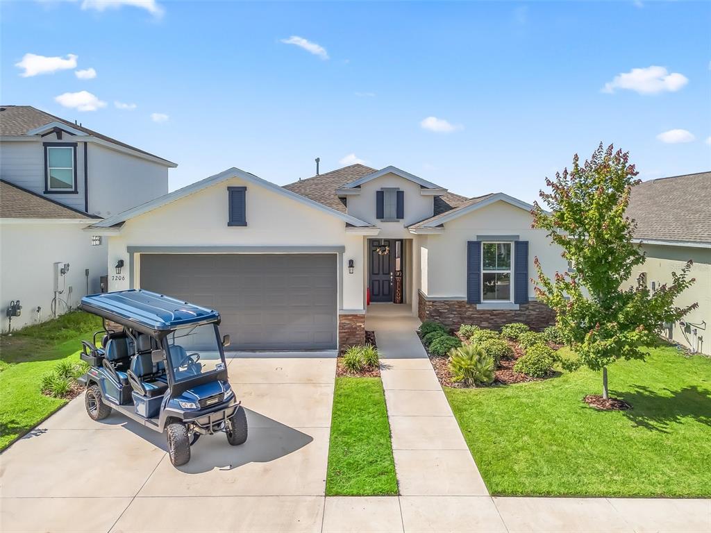 7206 Southwest 60th Lane Ocala, FL 34474 - Photo 47 of 50 a front view of a house with a garden and plants