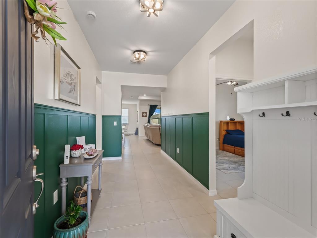 7206 Southwest 60th Lane Ocala, FL 34474 - Photo 5 of 50 a hallway with a refrigerator and a view of living room