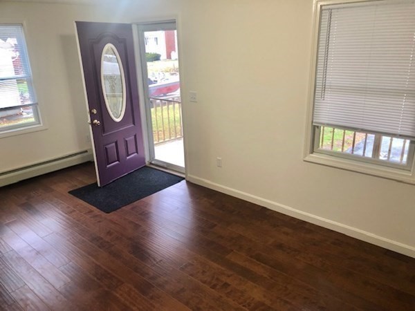 60 Cushing Road Webster, MA 01570 - Photo 5 of 30 an empty room with wooden floor mirror and windows