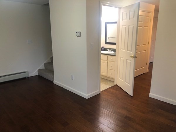 60 Cushing Road Webster, MA 01570 - Photo 6 of 30 a view of an empty room with wooden floor and a window