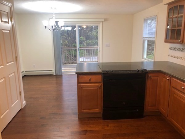 60 Cushing Road Webster, MA 01570 - Photo 8 of 30 a kitchen with granite countertop wooden cabinets and a wooden floor