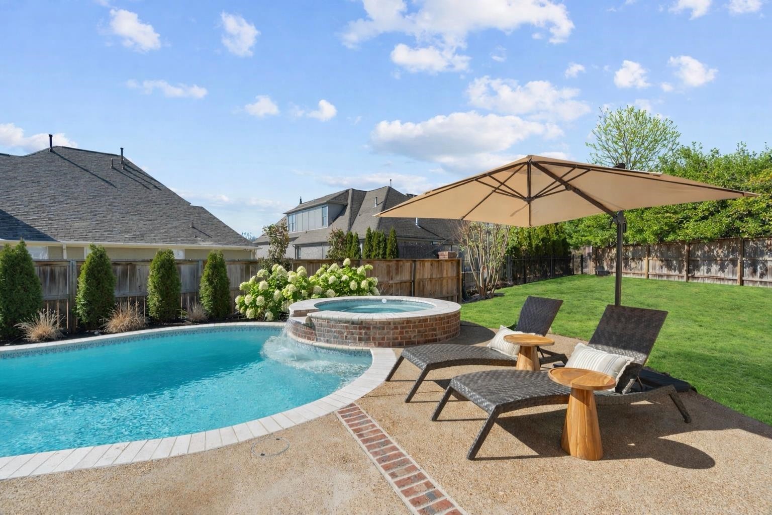10257 Old Course Cove Collierville, TN 38017 - Photo 6 of 38 a view of a patio with couches table and chairs under an umbrella