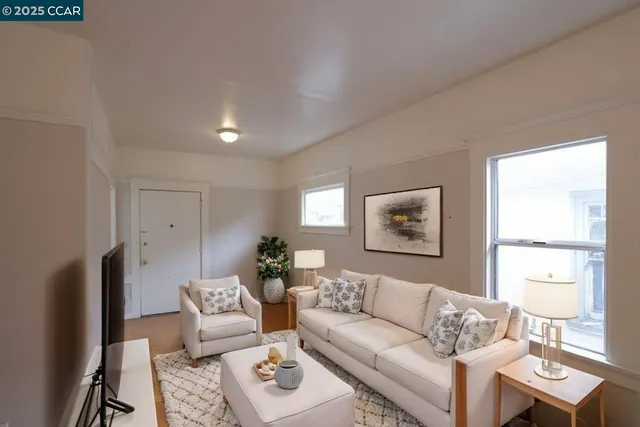 a living room with furniture fireplace and window