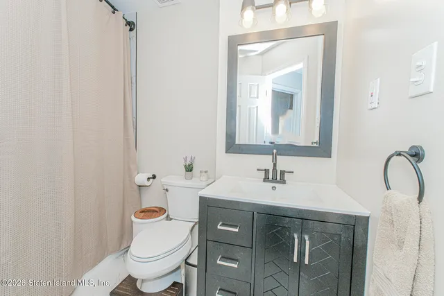 a bathroom with a sink toilet and mirror