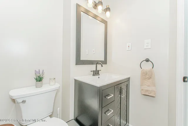 a bathroom with a sink toilet and mirror