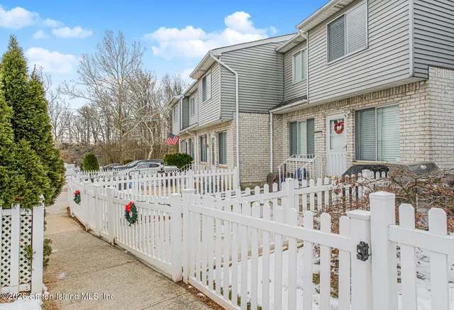 a view of a house with wooden fence