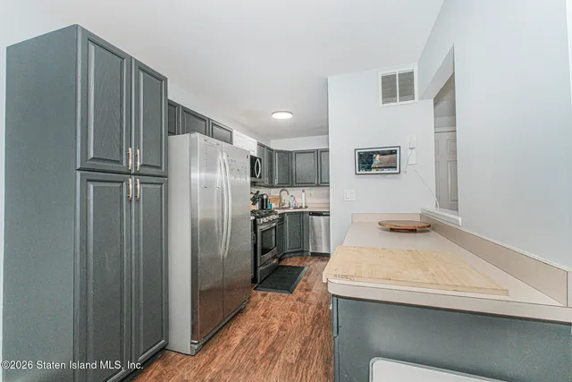 a kitchen with a refrigerator and a sink