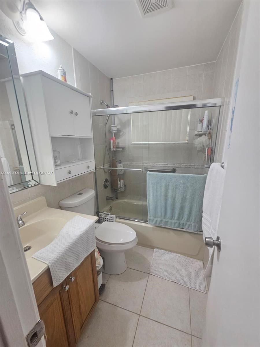 5010 Northwest 51st Court Tamarac, FL 33319 - Photo 11 of 16 a bathroom with a sink a toilet and shower