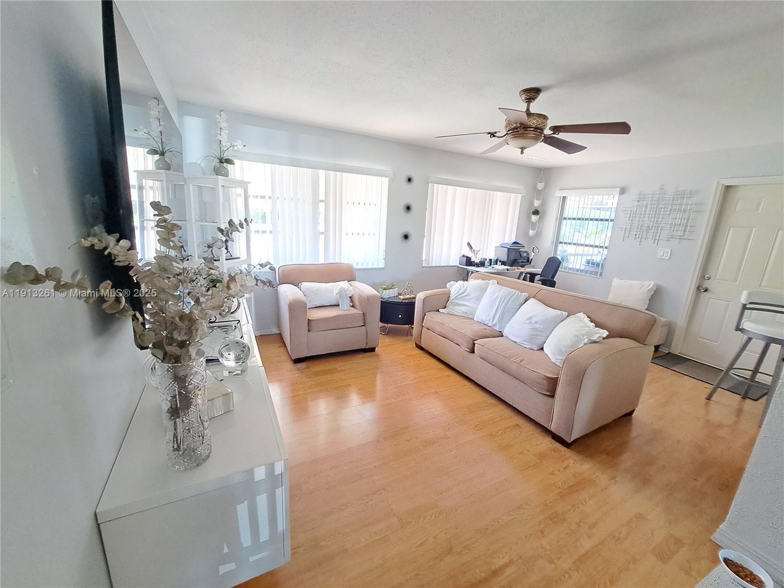 5010 Northwest 51st Court Tamarac, FL 33319 - Photo 2 of 16 a living room with furniture and a large window
