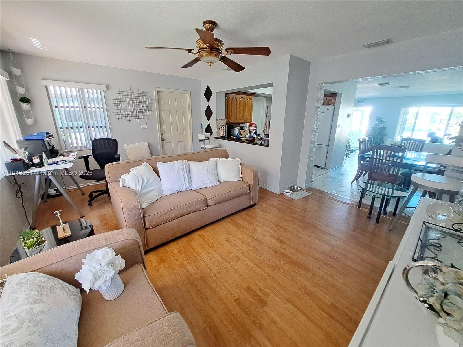 5010 Northwest 51st Court Tamarac, FL 33319 - Photo 3 of 16 a living room with furniture and wooden floor