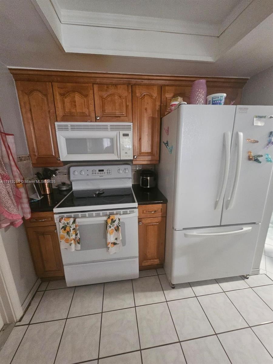 5010 Northwest 51st Court Tamarac, FL 33319 - Photo 6 of 16 a utility room with dryer and washer