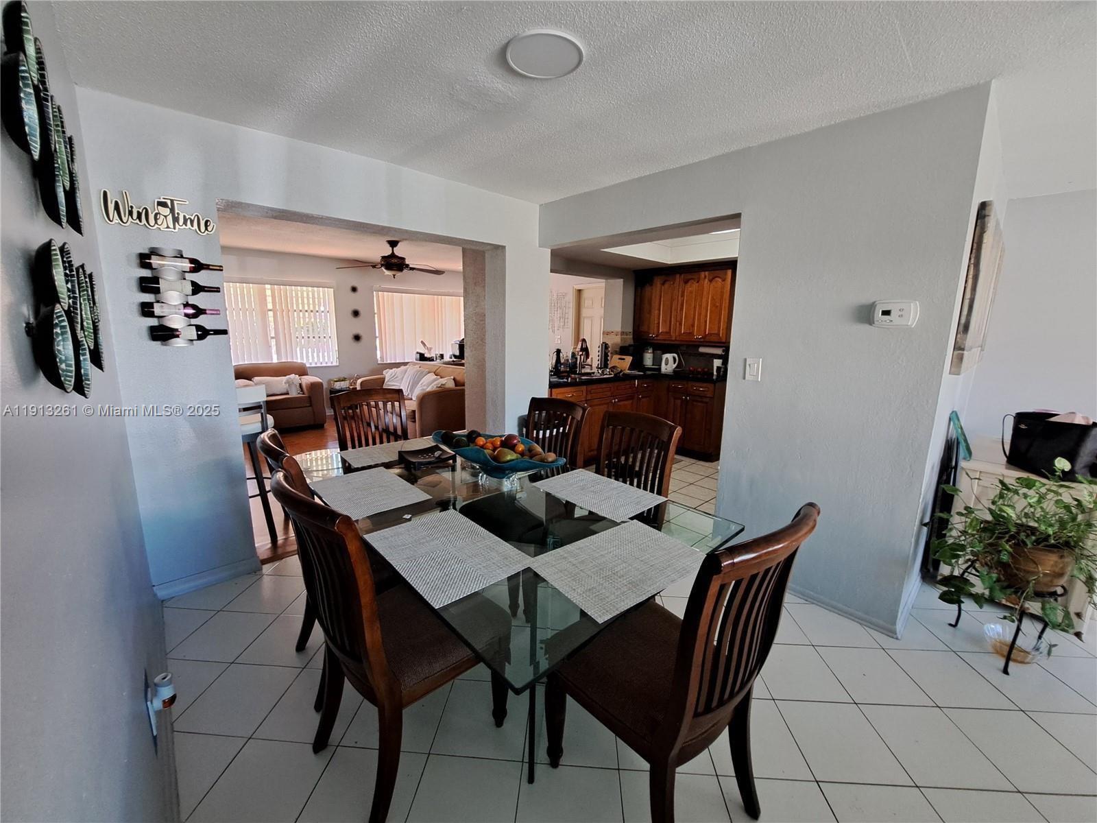 5010 Northwest 51st Court Tamarac, FL 33319 - Photo 7 of 16 a view of a dining room with furniture